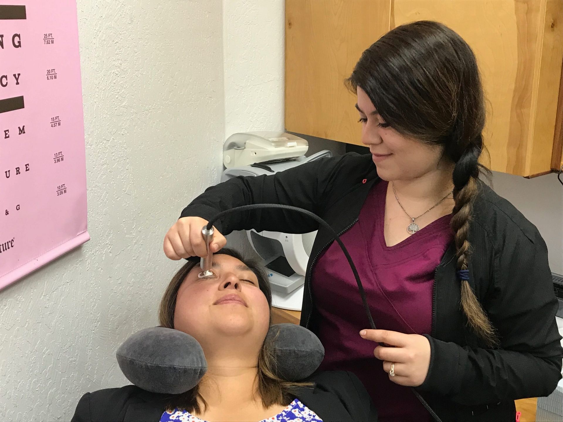 Technician performing an in-office dry-eye treatment