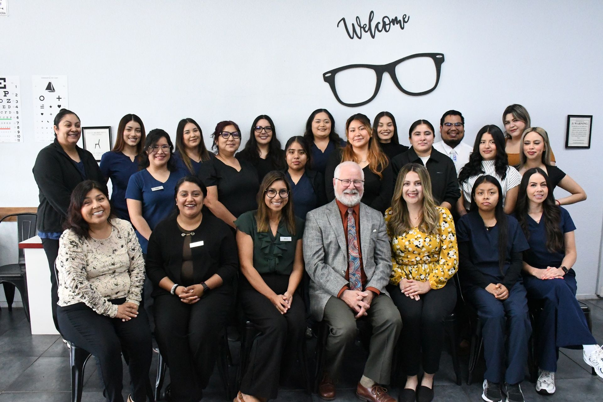The Vision Center of Santa Maria team, about two dozen staff in two rows with Dr. John Prewett seated in front